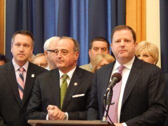 State Sen. Robert Kane, House and Senate GOP leaders Lawrence F. Cafero and John P. McKinney (left to right) and other Republican legislators (background) unveil their budget plan for 2014-15