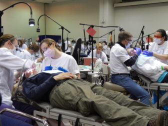 This is a photo of people receiving dental care at the CT Mission of Mercy free dental clinic.