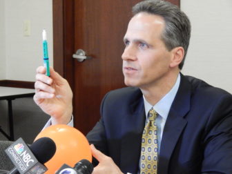 This is a photo of Griffin Hospital CEO Patrick Charmel holding up the type of insulin pen that was misused, potentially exposing patients to disease transmission.