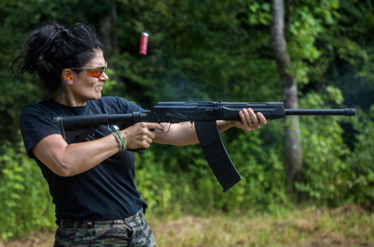 Kimberly Jones, a member of the Citizens Militia of Mississippi fires a semi-automatic tactical shotgun.