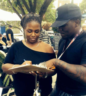 An Esty volunteer registers new voters in Danbury at the Caribbean Jerk Fest on Sept. 20.