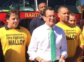 Gov. Dannel P. Malloy celebrated an endorsement by the Uniformed Professional Fire Fighters Association, then attacked Tom Foley.