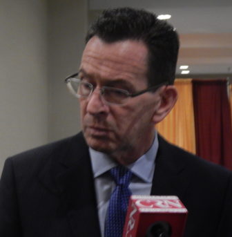 Gov. Dannel P. Malloy talks wth reporters after addressing the Connecticut Council of Small Towns