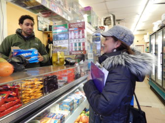 This is a picture of Marta Persia talking to Juan Brito about Obamacare in a mini mart in Hartford.