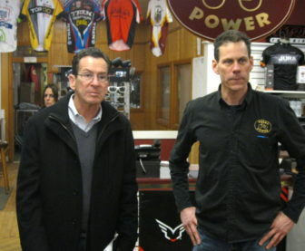Gov. Dannel P. Malloy and Bill McEnery, owner of the Pedal Power bicycle shop in Middletown, Monday.