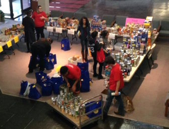 Volunteers organize donations from a food drive for the Norwalk Community College food pantry.