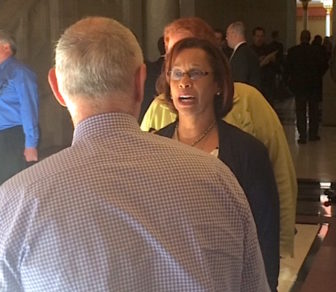 Rep. Toni Walker talks to Mark Ojakian, the governor's chief of staff, on the way into recent budget talks.