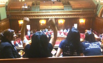 A group celebration in the Senate gallery after passage of a bill recognizing domestics as employees.