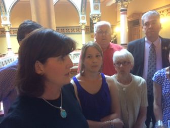 Karen Jarmoc, at left, of the Connecticut Coalition Against Domestic Violence with the family of Lori Jackson and legislators.