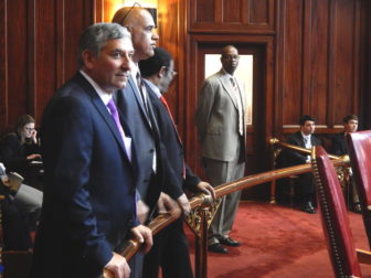 Senate Minority Leader Len Fasano, foreground, stands outside the Senate circle Moday.