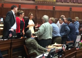 Republican legislators gather around House Minority Leader Themis Klarides before the beginning of the budget debate.