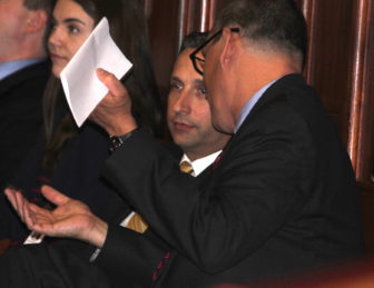 Senate Majority Leader Bob Duff, center, confers with Benjamin Barnes, the Malloy administration's budget director.