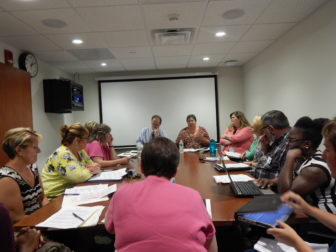 The Community Care Team at one of its Tuesday meetings to discuss care plans for some of its 208 clients.