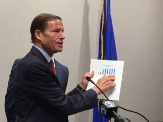 U.S. Sen. Richard Blumenthal criticizing airline fees at a press conference Tuesday.