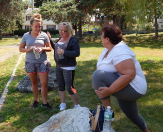 Cindy, center, jokes with Elizabeth Strange, who co-leads the fitness group, and Luz Esquilin during a walk at a Manchester park.