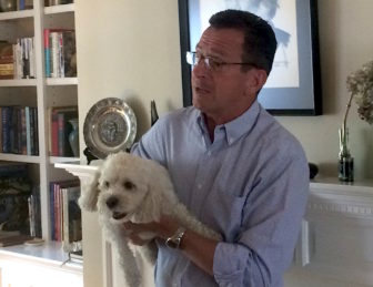 Gov. Dannel P. Malloy had an easier time grabbing his New Hampshire audience's attention once he picked up the family dog, Bella.
