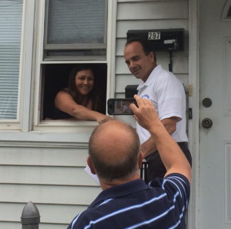 Joe Ganim on a recent day of campaigning: A handshake through an open window, and photo bound for Facebook.