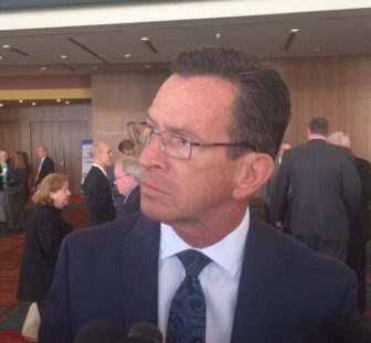 Gov. Dannel P. Malloy listening to a reporter's question Tuesday at a meeting of the Connecticut Conference of Municipalities.