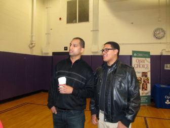 Dereck Torres, at right, walks around a recent school choice fair in Hartford.