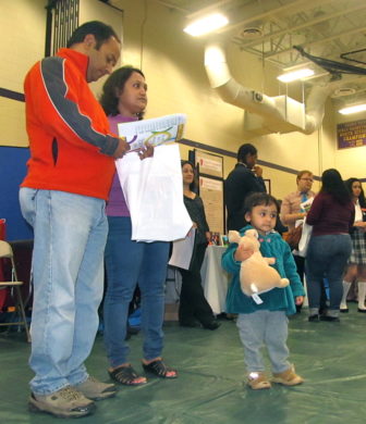 Suhash Ghosh and his wife Neeta Roy search for a school for their daughter next year at the School Choice Fair in Hartford recently.