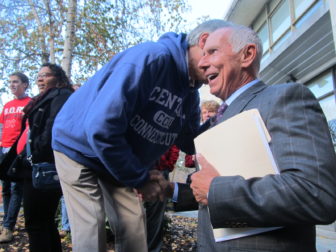 Peter Tercyak talks with CSCU President Mark Ojakian before heading to the megaphone.