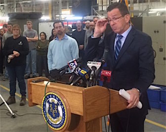 Gov. Dannel P. Malloy takes questions about GE at a hastily arranged appearance at Pegasus Manufacturing. At left is the company president, Chris DiPentima.
