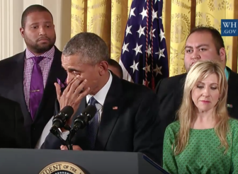 Obama wipes away tears as Jimmy Green, left, who lost his daughter Ana in the Sandy Hook shootings, looks on.