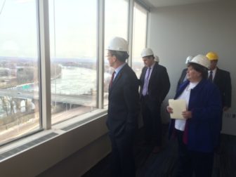 The governor checks the view from what will be the office of Kevin Sullivan, commissioner of revenue services.