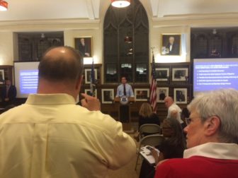 A correction employee challenges Gov. Dannel P. Malloy. At right is Lt. Gov. Nancy Wyman.