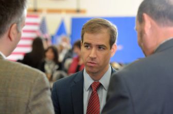 Hartford Mayor Luke Bronin answers questions from the press at Hillary Clinton's campaign forum on gun violence at the Wilson-Gray YMCA Thursday
