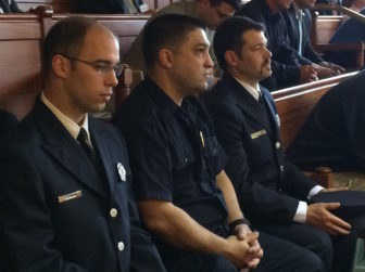Three members of Uniformed Professional Fire Fighters of Connecticut listen to the debate in the Senate.