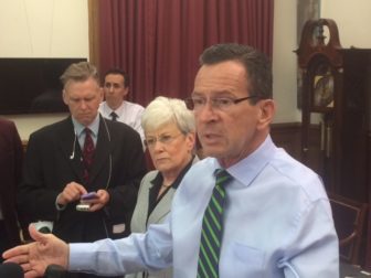 Gov. Dannel P. Malloy talks to reporters. At left, Lt. Gov. Nancy Wyman.