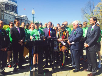 Monte Frank, leader of the "Team26" cyclists who arrived in Washington from Newtown Tuesday, is surrounded by members of the Connecticut congressional delegation and his fellow riders as he advocates for federal action on gun control.