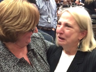 Retiring Rep. Roberta Willis, right, gets a hug from Rep. Cathy Abercrombie after the House voted to rename a scholarship in her honor.