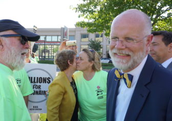 Comptroller Kevin Lembo mingled outside. His aide, Martha Carlson, kisses Lori Pelletier, the AFL-CIO president.