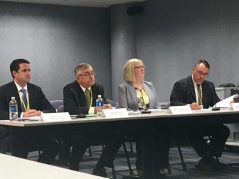 ConnectiCare officials listen during a public hearing on their proposed rate increases Thursday.