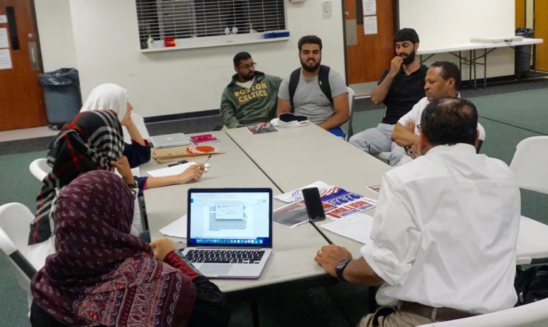 Mansoor leading a planning session for a conference on Muslim political activism.