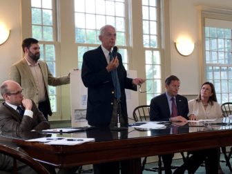 Stoninington First Selectman Rob Simmons, standing, speaks against the proposed rail changes. He is flanked by state Rep. Devin Carney, left, and U.S. Sen. Richard Blumenthal and Old Lyme First Selectwoman Bonnie Reemsnyder, right.