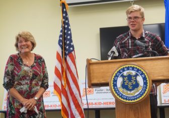 Kathy Coale laughs as her nephew, Avery, thanks their DCF social worker, Adam Texeira.