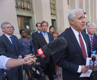 David Rosen, at far left, and Joseph Moodhe, listen to the chairman of CCJEF, Herbert Rosenthal.