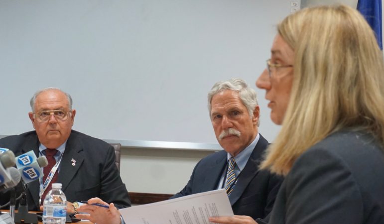 Ethics board members Charles F. Chicano and Kevin Johnston listen to Kimberly Knox, lawyer for Katharine L. Wade.