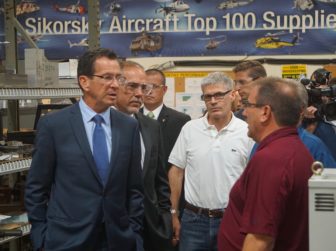 Gov. Dannel P. Malloy and House Majority Leader Joe Aresimowicz listening to a Sikorsky supplier, Mark Labbe, right.