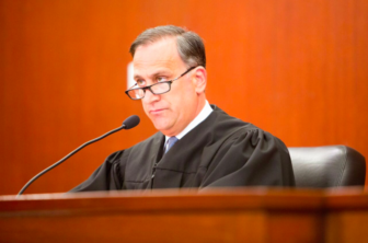 Judge Thomas Moukawsher reading his decision.