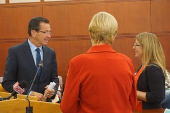 Gov. Dannel P. Malloy with Sen. Cathy Osten, back to camera, and Allison Quirion, the founder of the Connecticut chapter of the advocacy group, Decoding Dyslexia.