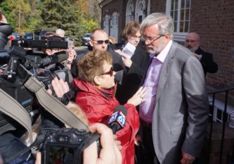 Betty Boukus and William Petit outside his home.