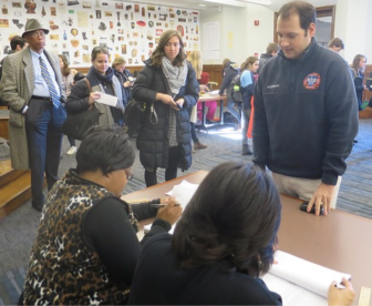 Myles Alderman reaches the checkers after two hours and 20 minutes in line to vote at New Haven's Hall of Records.