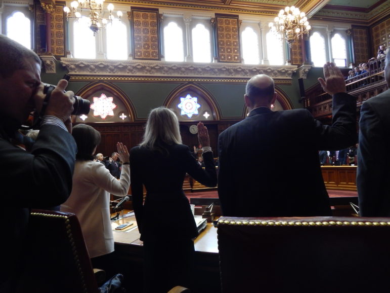 Senators take the oath of office on opening day of the 2017 legislative session. From left are Senators Gayle Slossberg of Milford, Joan Hartley of Waterbury and Joe Markley of Southington.
