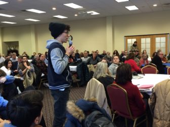 Elliott Skidmore, a sophomore, asks a question at the forum.