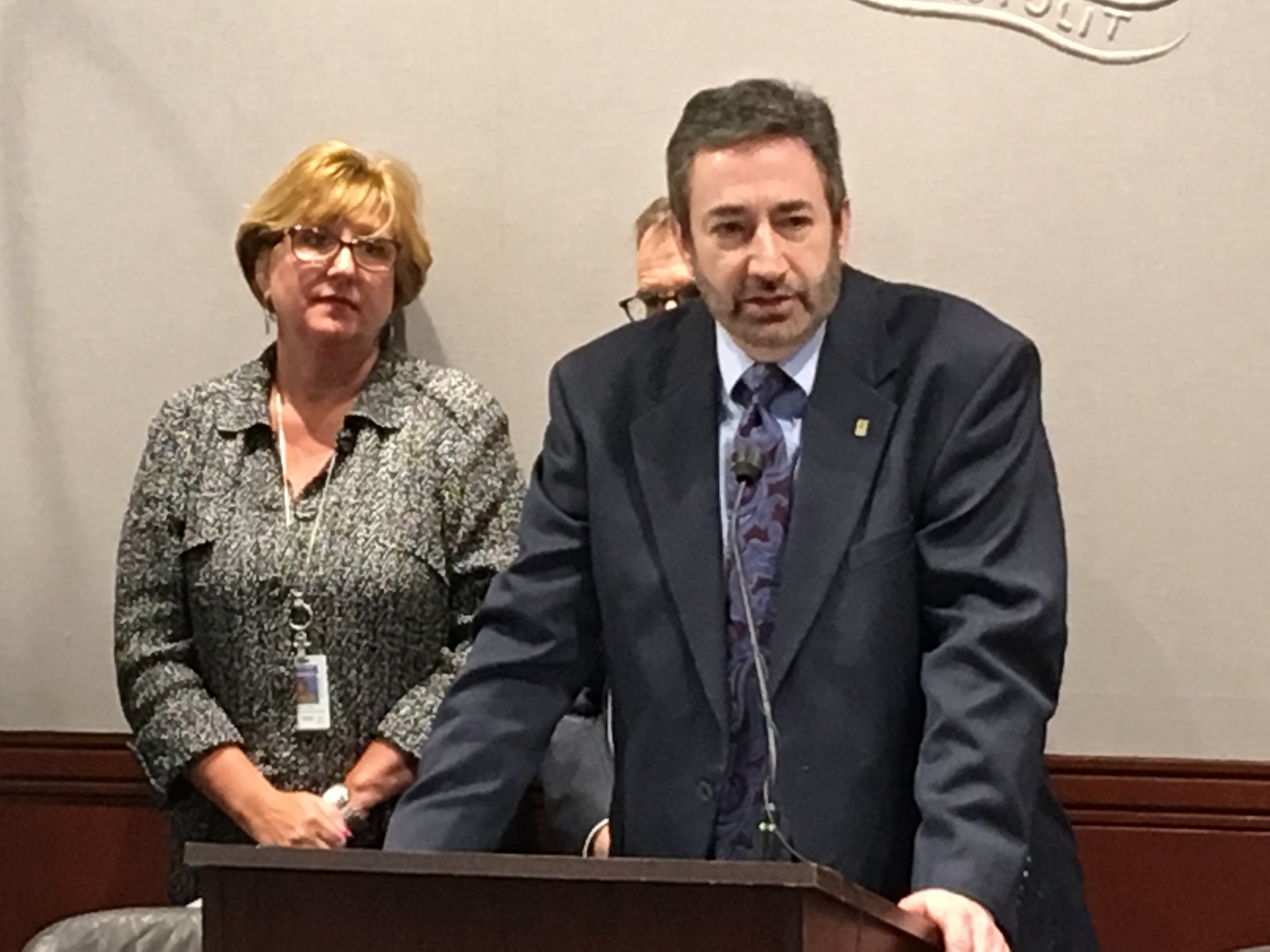 Barry Simon, president and CEO of Oak Hill, talks with reporters. Rep. Cathy Abercrombie, D-Meriden, in background.