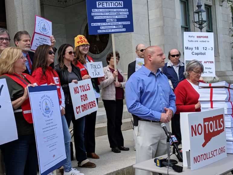 Patrick Sasser, founder and leader of No Tolls CT, in foreground in blue shirt, rallied with a small group of poll opponents at the Capitol Thursday. They delivered petitions with more than 100,000 signatures to the governor's office.